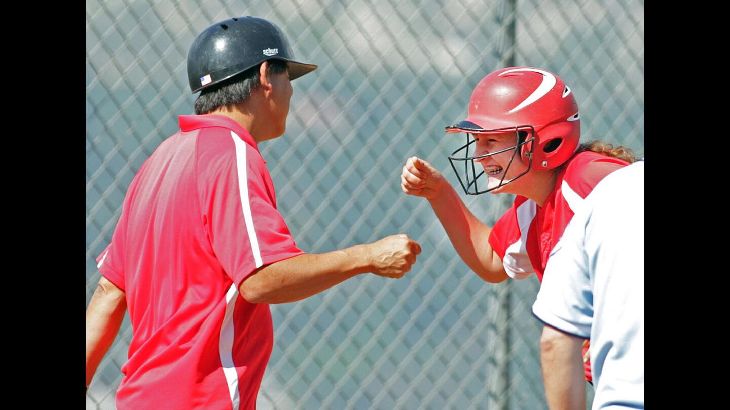 Flintridge Sacred Heart's Courtney Rasic fist bumps coach Kirk Nishiyama after hitting a 3-run triple against Sierra Vista in a CIF Southern Section Division V wildcard softball game at FSHA on Tuesday, May 17, 2016. Sacred Heart won the game.