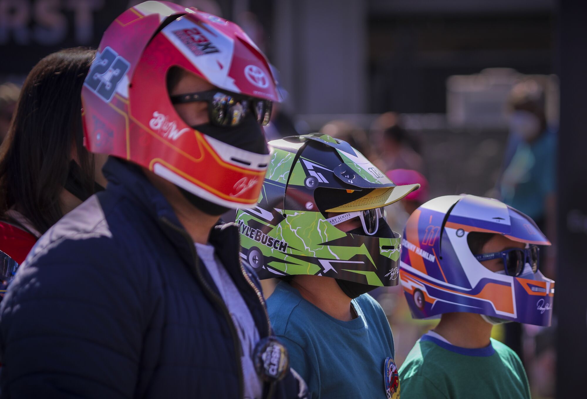 Fabian Martinez and his sons Jonathan and Alexander wear racing helmet hats.