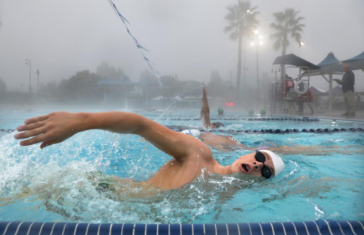 La Mirada Armada swimmers including Andrew Salladin warm up in the early morning hours before the Kevin Perry Invitational.