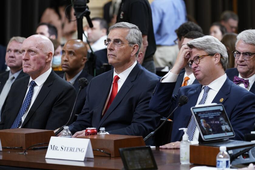 From left, Arizona House Speaker Rusty Bowers, left, Georgia Secretary of State Brad Raffensperger and Georgia Deputy Secretary of State Gabriel Sterling, listen as the House select committee investigating the Jan. 6 attack on the U.S. Capitol continues, at the Capitol in Washington, Tuesday, June 21, 2022. (AP Photo/J. Scott Applewhite)