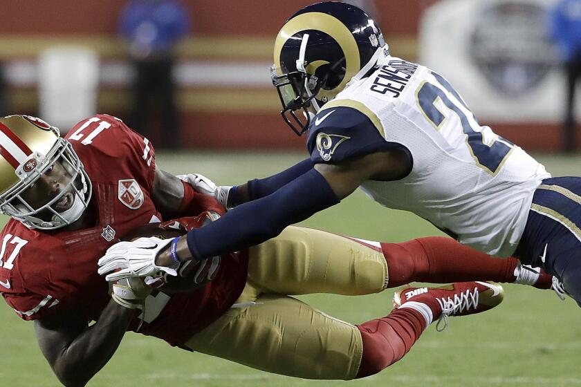 Rams cornerback Coty Sensabaugh is unable to break up a pass to 49ers receiver Jeremy Kerley during the season opener Sept. 12.