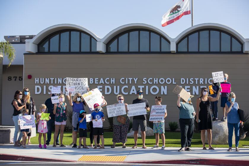 Parents and students hold a rally at the Huntington Beach City School District on Tuesday, September 22, to protest the district's reopening plans.
