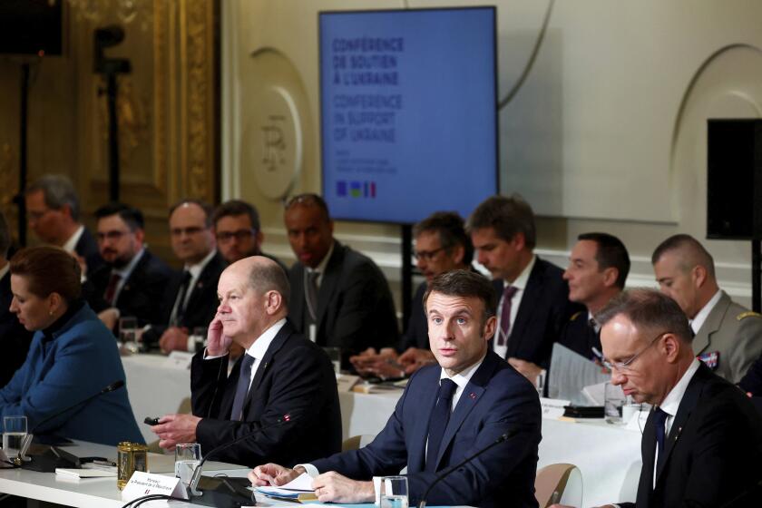 French President Emmanuel Macron, center right, delivers a speech at the Elysee Palace in Paris, Monday, Feb. 26, 2024. More than 20 European heads of state and government and other Western officials are gathering in a show of unity for Ukraine, signaling to Russia that their support for Kyiv isn't wavering as the full-scale invasion grinds into a third year. (Gonzalo Fuentes/Pool via AP)