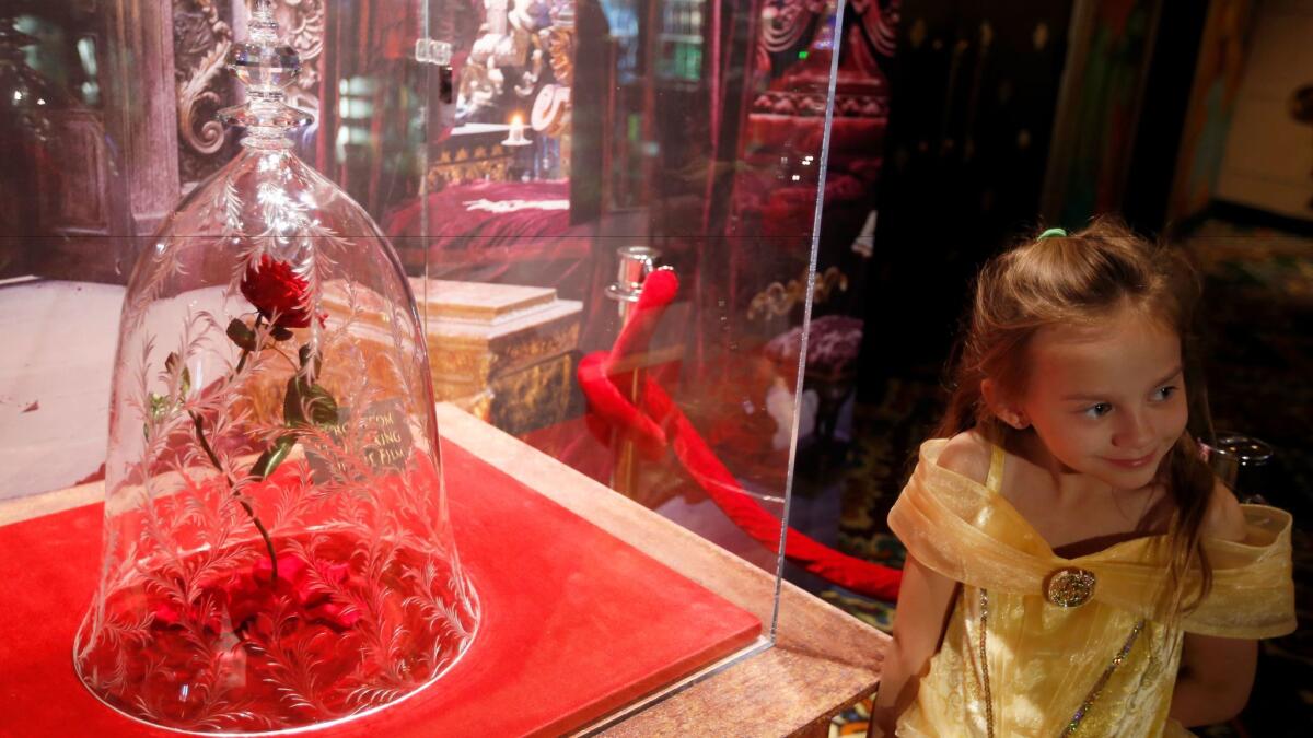 Rillie Duce, 6, of Tehachapi poses with the rose in Hollywood's El Capitan lobby at the first L.A. "Beauty and the Beast" public screening.