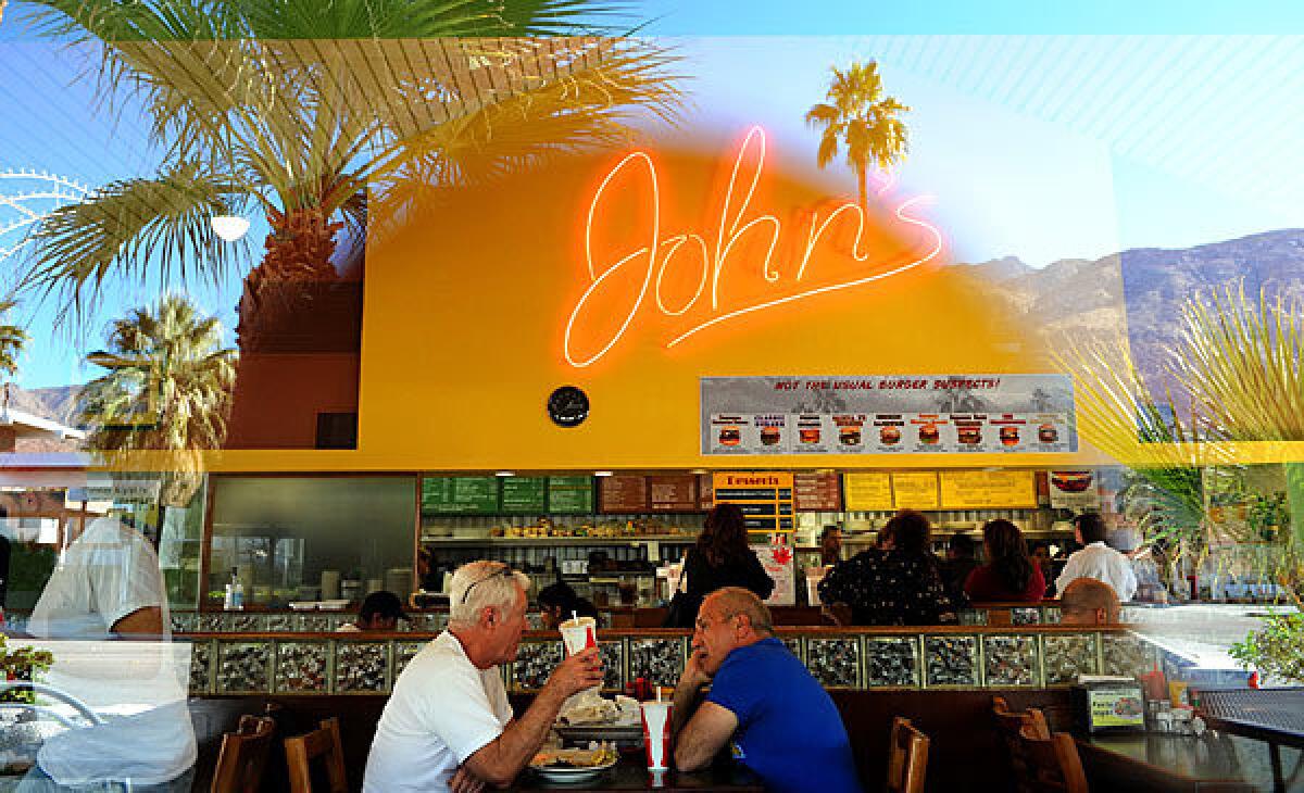 Locals Jim Gilroy, left, and Rocky Laudadio dine at John's in Palm Springs. You'll find lots of heart-stopping dishes on the menu, including the "Heartstopper Burger," a high-cholesterol cheeseburger that includes two sausage patties, bacon and an egg.