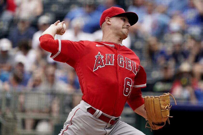 Los Angeles Angels starting catcher Janson Junk throws during the first inning of a baseball game against the Kansas City Royals Wednesday, July 27, 2022, in Kansas City, Mo. (AP Photo/Charlie Riedel)