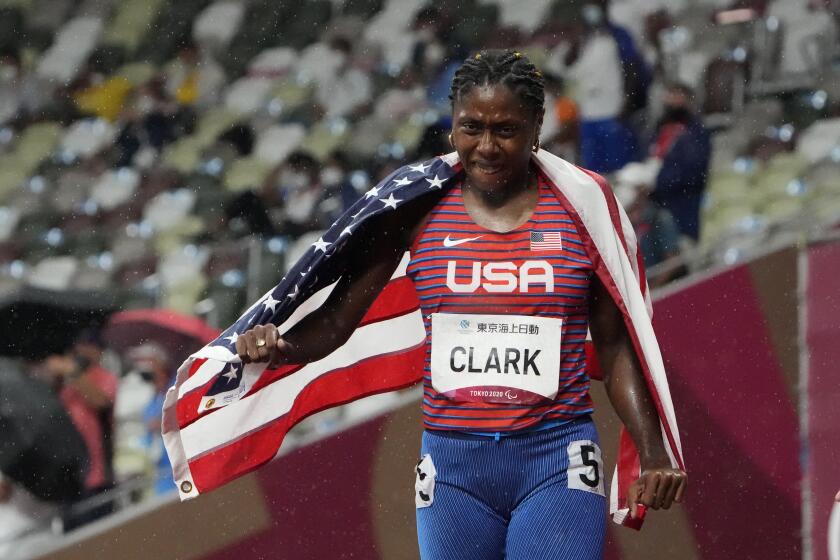 Breanna Clark of the United States celebrates after winning the women's 400m T20 final during the Tokyo 2020 Paralympics Games at the National Stadium in Tokyo, Japan, Tuesday, Aug. 31, 2021. (AP Photo/Eugene Hoshiko)