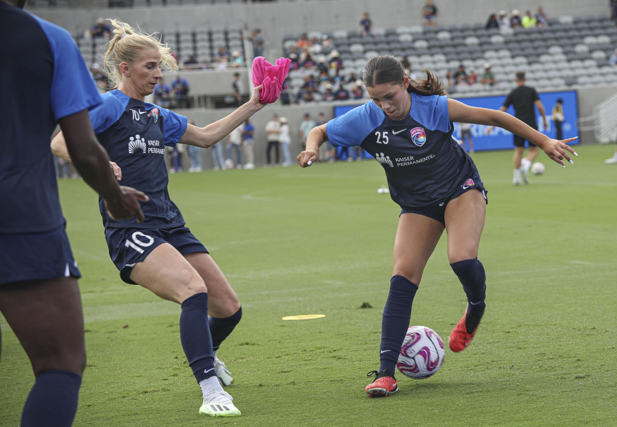 Two women playing soccer