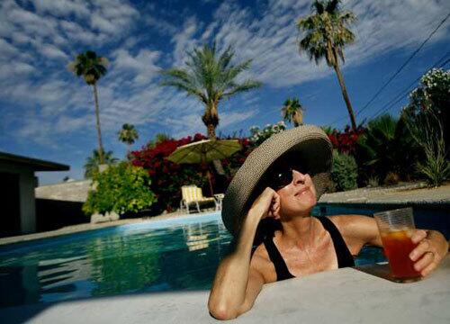 Looking not unlike one of the ladies of leisure in her trademark, sun-soaked paintings, D.J. Hall relaxes at her Palm Desert home. Her work is the subject of a 35-year retrospective at the Palm Springs Art Museum -- an exhibition of about 100 works -- as well as a show at Koplin Del Rio Gallery in Culver City.