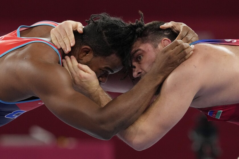 Cuba's Reineris Salas Perez, left, competes a