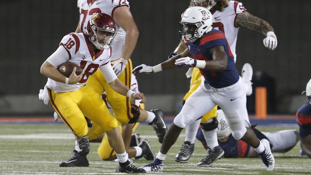 USC quarterback JT Daniels dodges an Arizona defender in the first half Saturday.