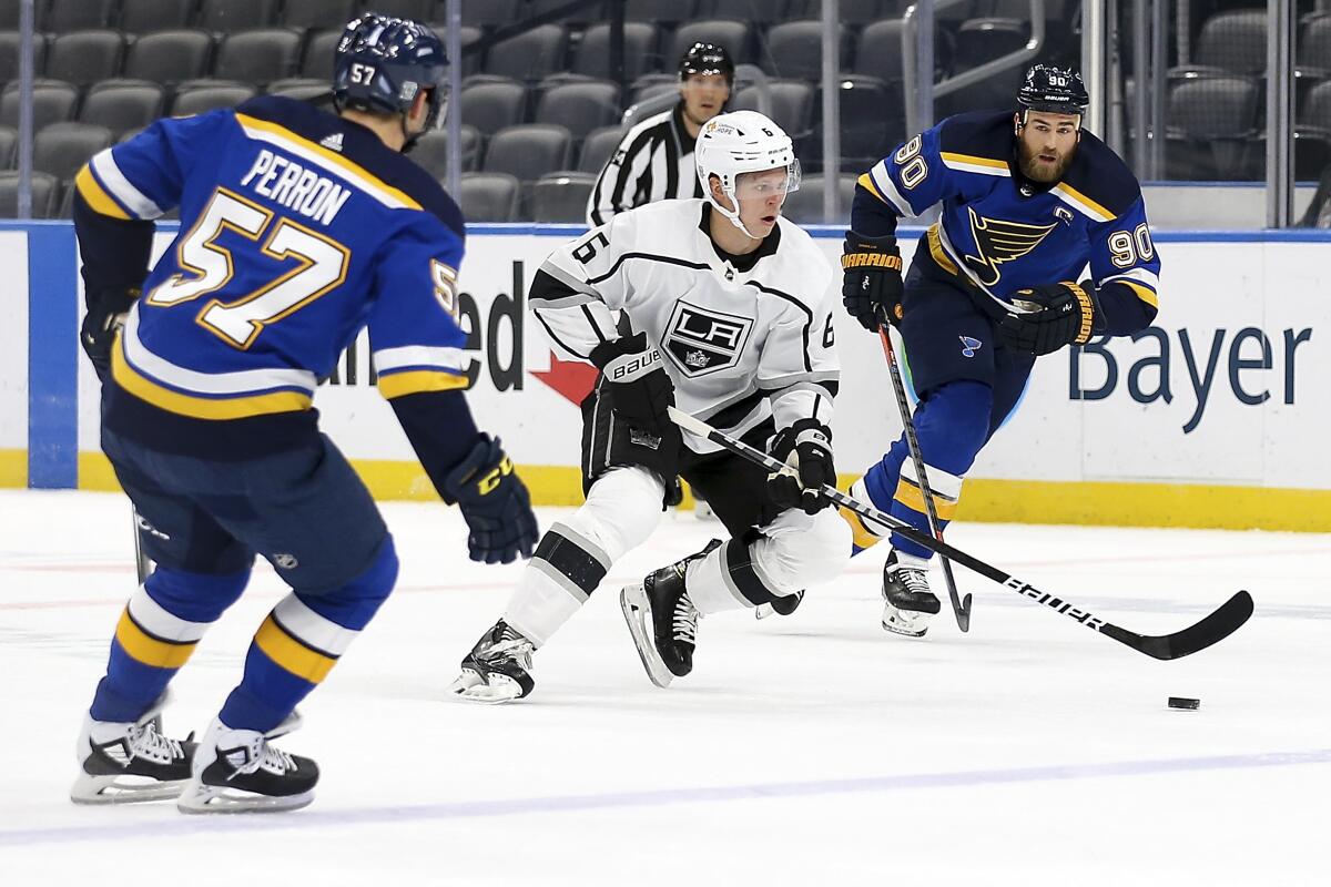 Kings' Olli Maatta controls the puck while under pressure from St. Louis Blues' Ryan O'Reilly and David Perron.