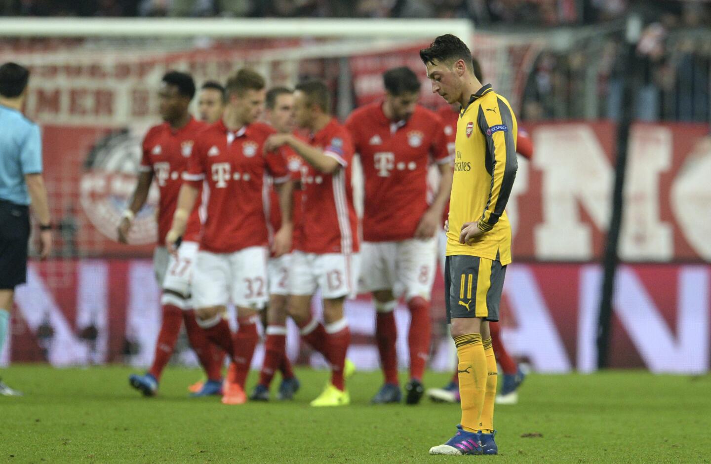 Arsenal's Mesut Ozil, right, looks disappointed after Bayern scored their fifth goal in the soccer Champions League round of 16 first leg soccer match between Bayern Munich and Arsenal FC in Munich, southern Germany, Wednesday, Feb. 15, 2017. (Andreas Gebert/dpa via AP)