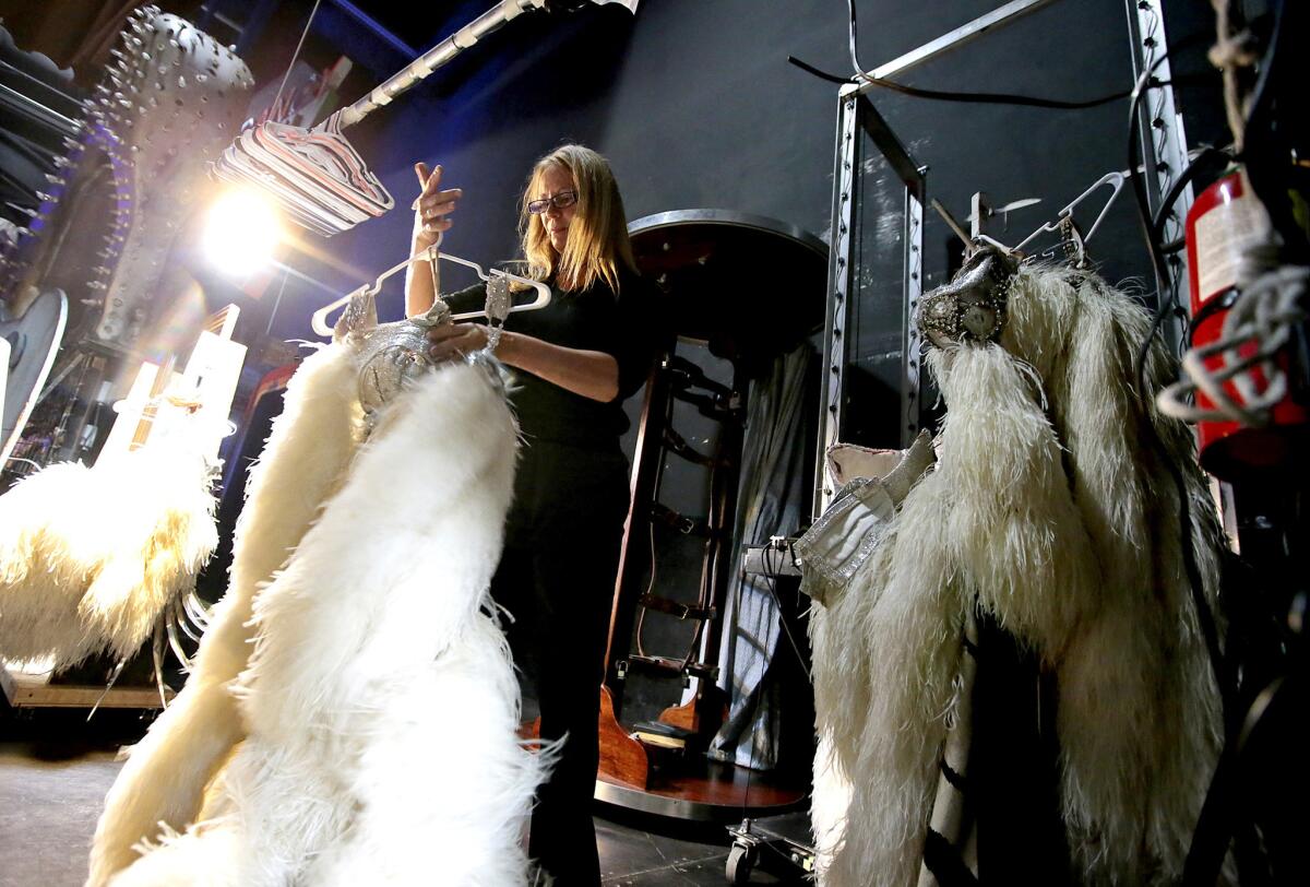 Dresser Paula Nyland hangs a dancer's costume backstage before "Vegas! The Show" at Planet Hollywood's Saxe Theater in Las Vegas.