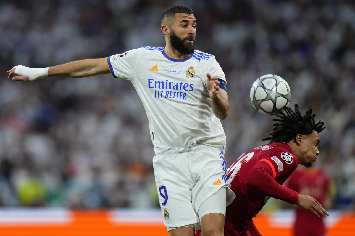 FILE - Real Madrid's Karim Benzema, left, jumps for a header with Liverpool's Trent Alexander-Arnold during the Champions League final soccer match between Liverpool and Real Madrid at the Stade de France in Saint Denis near Paris, on May 28, 2022. (AP Photo/Petr David Josek, File)