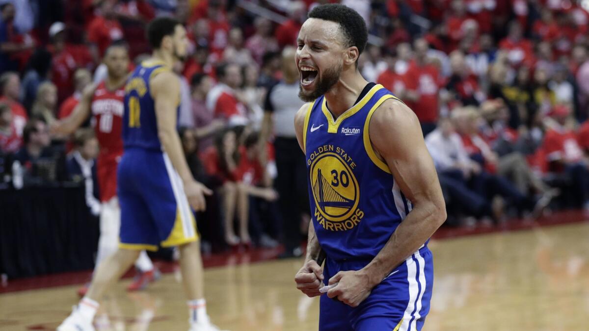 Golden State Warriors guard Stephen Curry celebrates the team's win over the Houston Rockets in Game 6 of a second-round NBA playoff series on Friday in Houston.