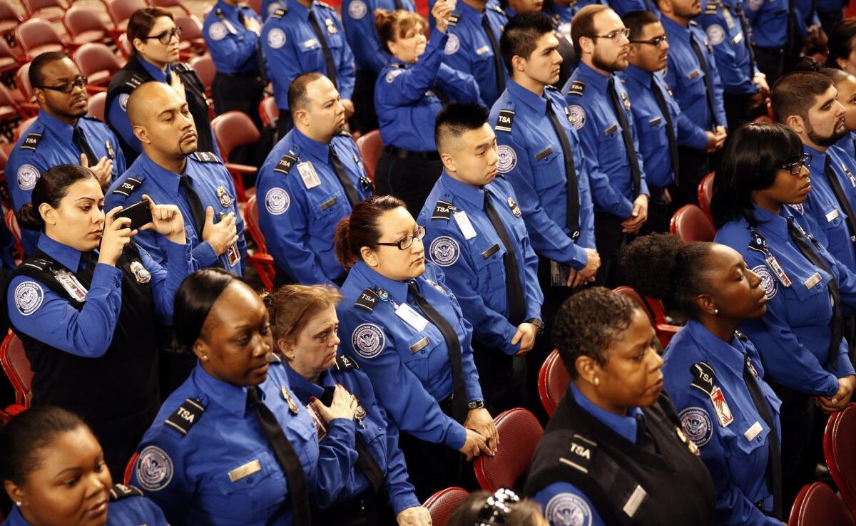 Transportation Security Administration officers stand together during the public memorial service for slain TSA agent Gerardo Hernandez at the Los Angeles Sports Arena on Tuesday.