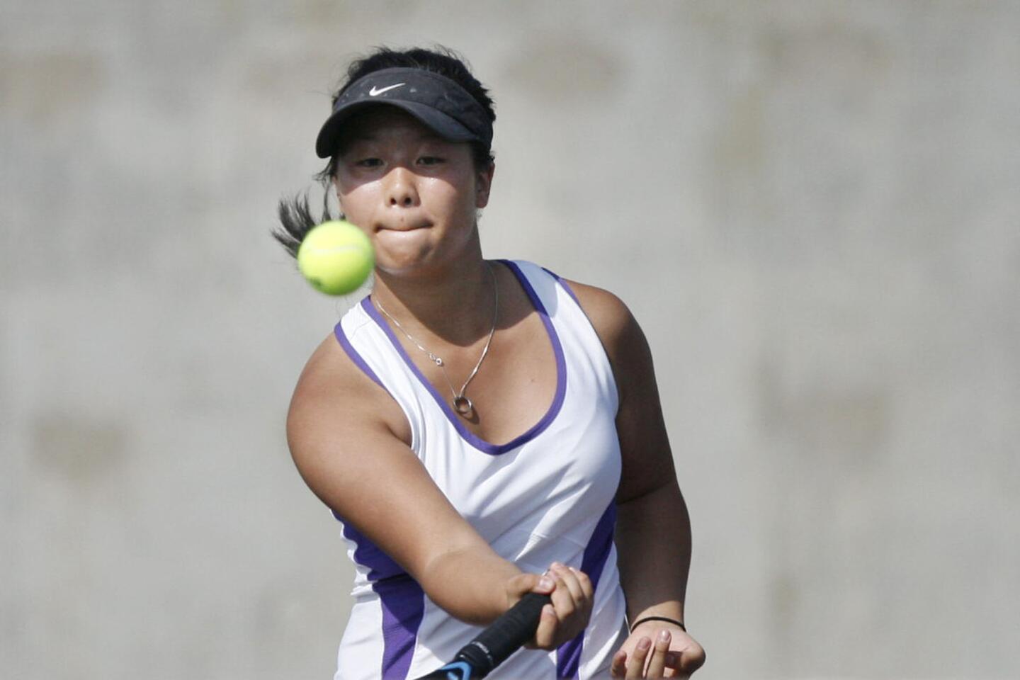 Hoover's Sara Kim hits the ball during a match against Burroughs at Hoover High School in Glendale on Tuesday, September 11, 2012.