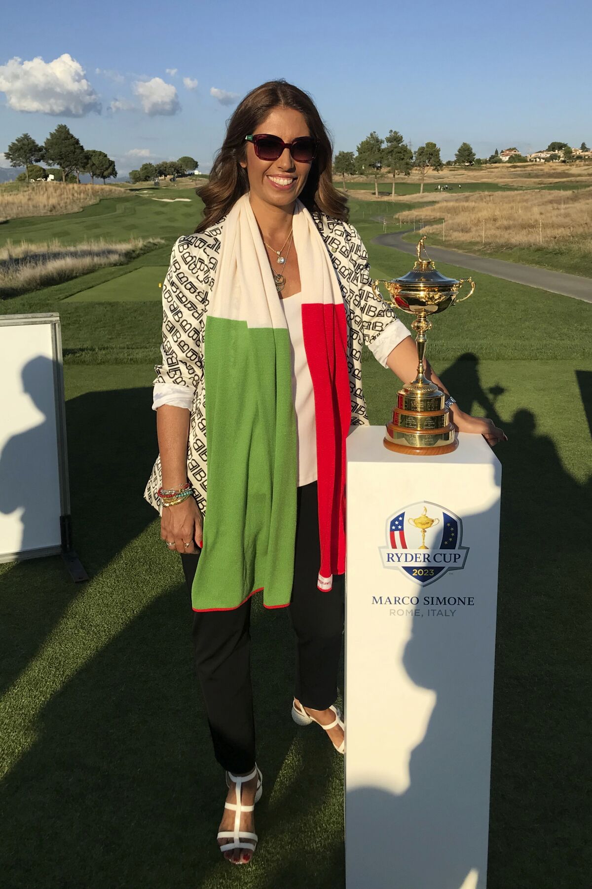 Lavinia Biagiotti Cigna poses by the Ryder Cup trophy at the Marco Simone Golf and Country Club, in Guidonia, on the outskirts of Rome, Wednesday, Sept. 1, 2021. An 11th-century castle. A grove of olive trees. The remains of an ancient Roman villa. Views of St. Peter’s Basilica on the horizon. The terrain surrounding and comprising the Marco Simone Golf and Country Club on Rome’s outskirts that will host the 2023 Ryder Cup is quintessential Italy. And no one knows that better than fashion designer Lavinia Biagiotti Cigna, who owns and runs the club. Biagiotti Cigna also lives on the club grounds with her three dogs — in the castle, of course, which is situated between a bend in the course wedged between the sixth and eighth holes. Astronomer Galileo Galilei once lived in the castle, too. (AP Photo/Andrew Dampf)