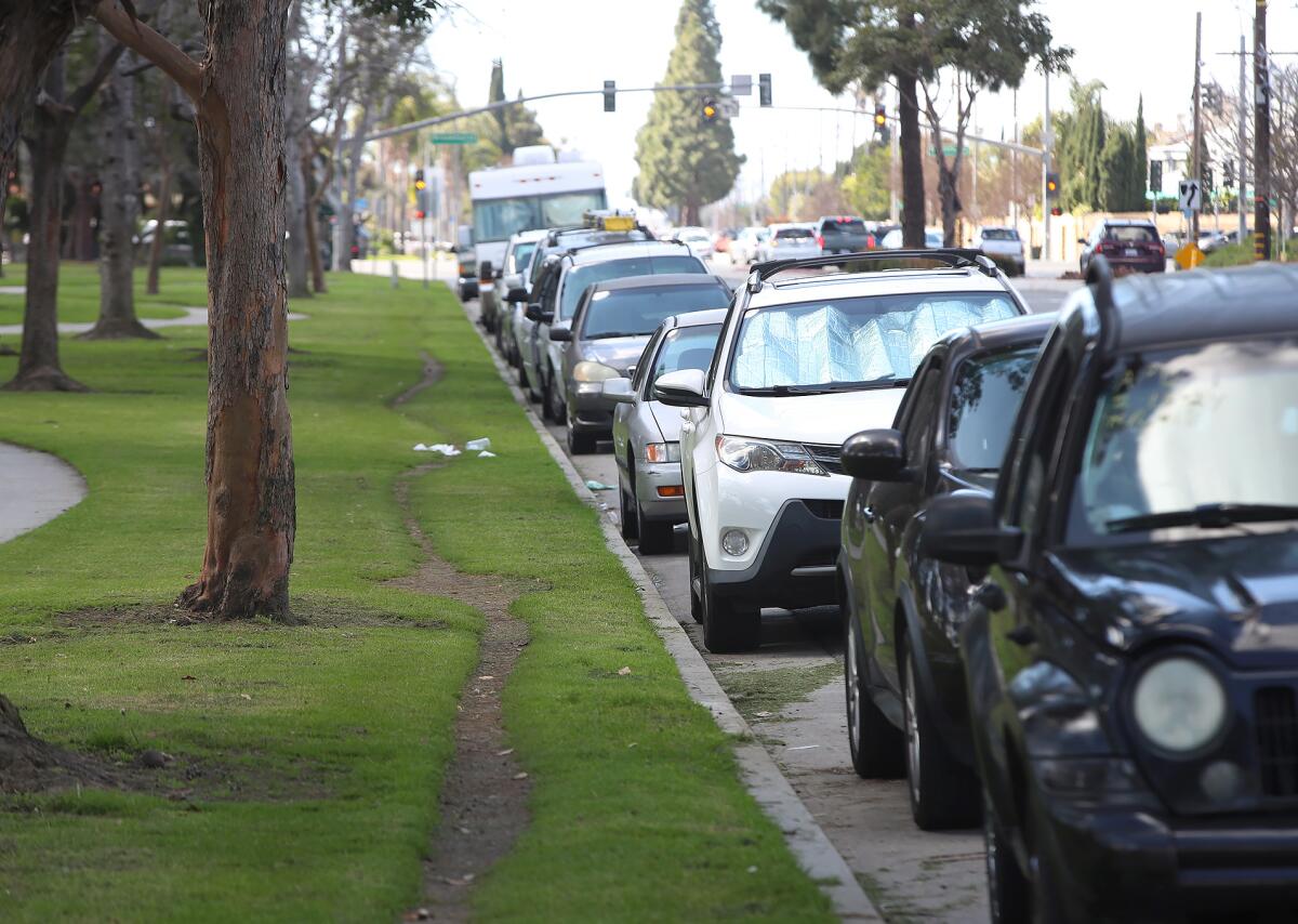 Parked cars along Edinger Avenue at Mile Square Park in Fountain Valley on Tuesday.