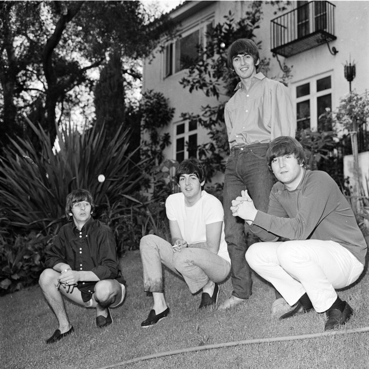 The Beatles relax on the lawn of their rented Bel-Air mansion in August 1964.