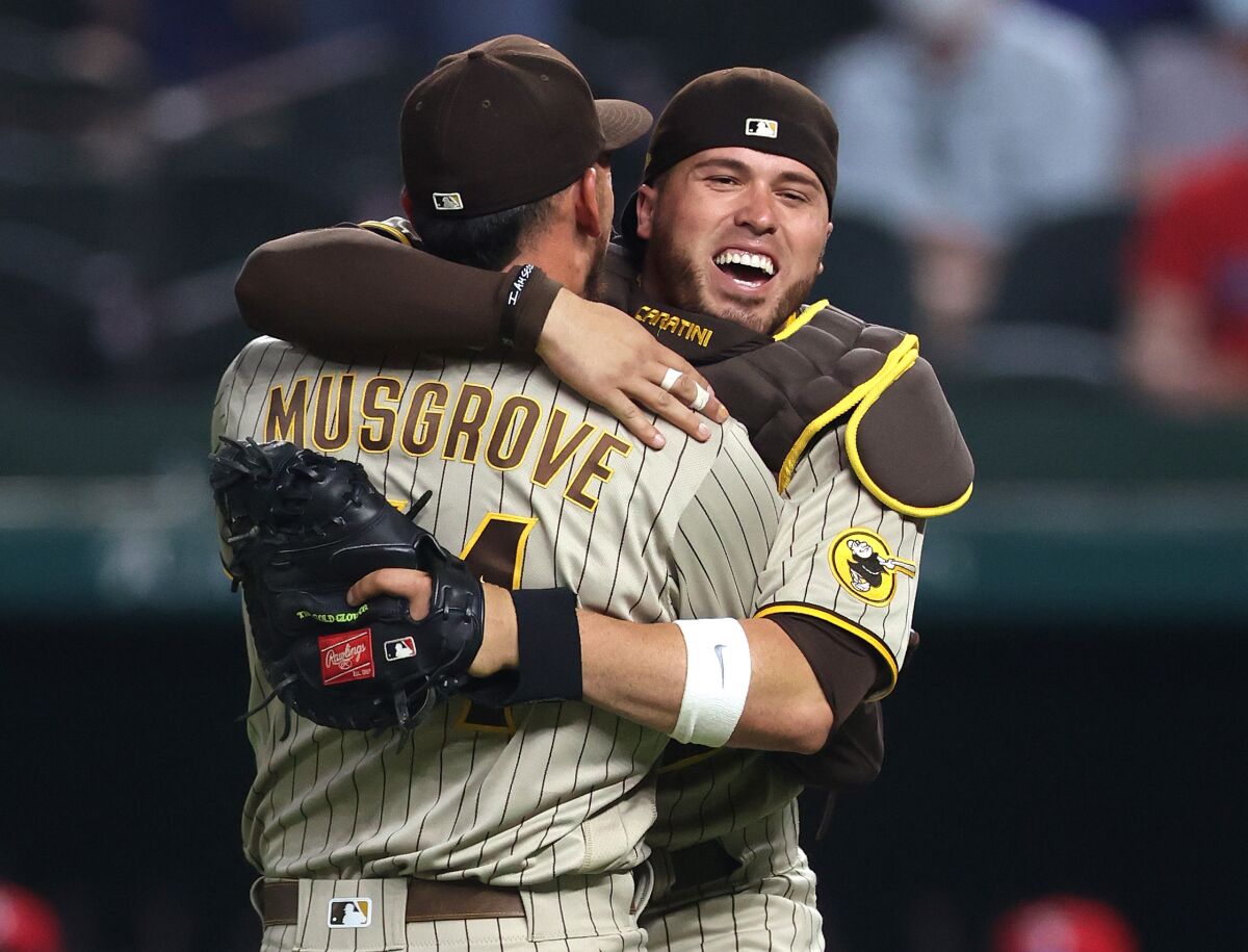 The Padres' Joe Musgrove celebrates with Victor Caratini 