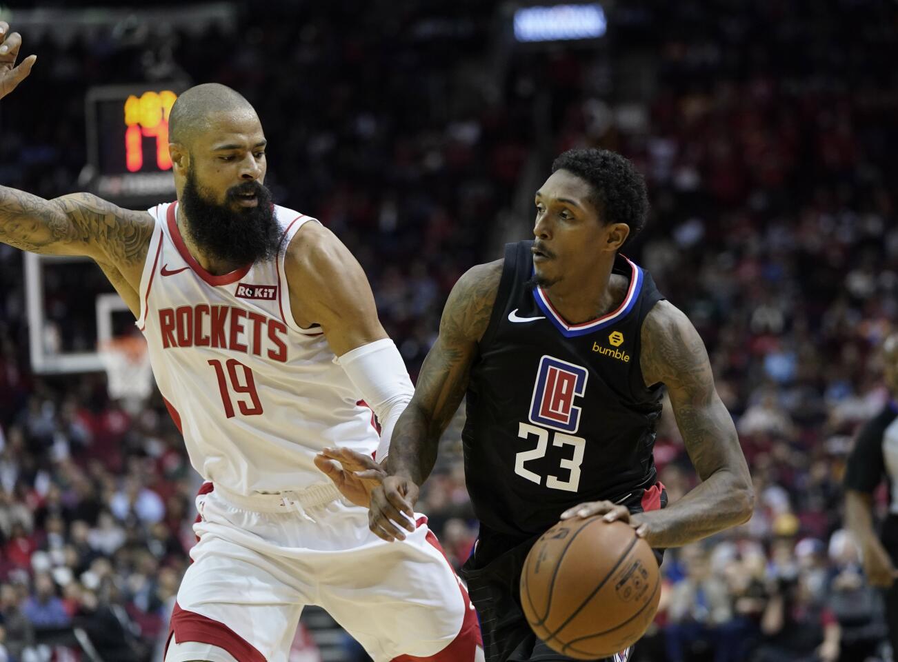 Clippers guard Lou Williams (23) drives toward the basket against Rockets center Tyson Chandler (19) defends during the first half of a game Nov. 13.