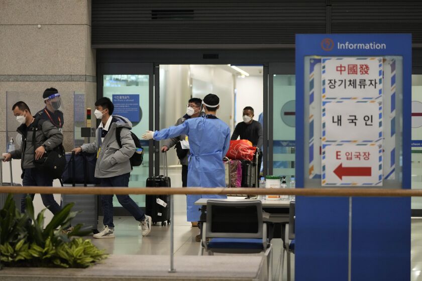 Passengers coming from China arrive at the Incheon International Airport in Incheon, South Korea, on Jan. 14, 2023. South Korea says it will continue to restrict the entry of short-term travelers from China through the end of February over concerns that the spread of COVID-19 in that country may worsen following the Lunar New Year’s holidays. (AP Photo/Ahn Young-joon)