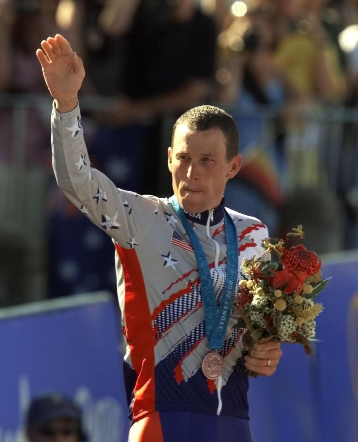Lance Armstrong waves after receiving the bronze medal in the men's individual time trials at the 2000 Summer Olympics.