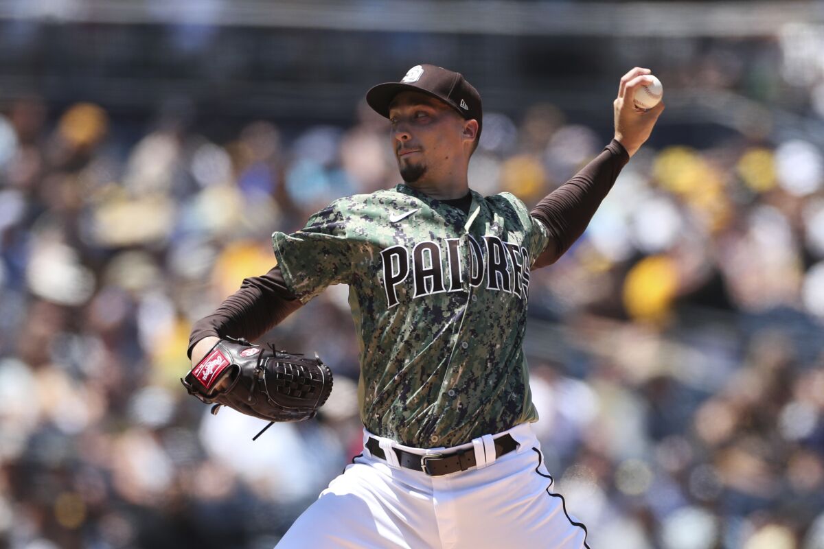 San Diego Padres starting pitcher Blake Snell delivers to an Arizona Diamondbacks batter in the first inning of a baseball game Sunday, Aug. 8, 2021, in San Diego. (AP Photo/Derrick Tuskan)