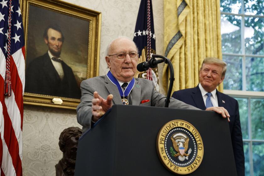 President Donald Trump listens during a Presidential Medal of Freedom ceremony for former NBA basketball player and coach Bob Cousy, of the Boston Celtics, in the Oval Office of the White House, Thursday, Aug. 22, 2019, in Washington. (AP Photo/Alex Brandon)
