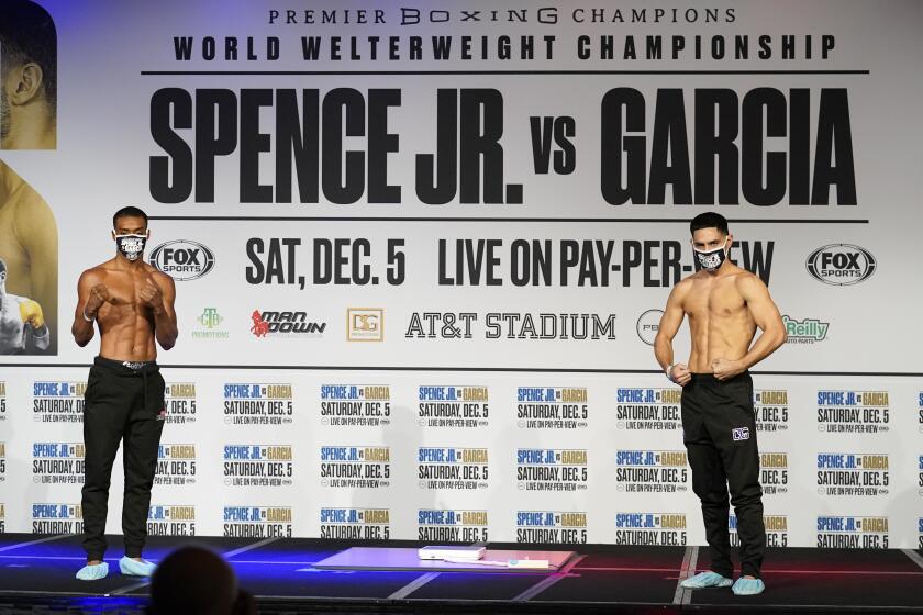 Boxers Errol Spence Jr., left, and Danny Garcia, right, pose after weigh-ins for their title match in Dallas.