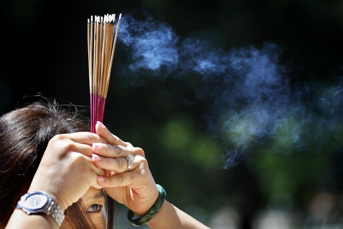 Cynthia Le prays at Bao Quang Temple.