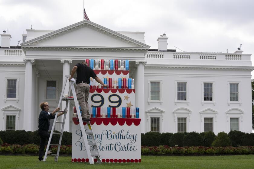Workers work on a wooden cake display on the North Lawn of the White House, Saturday, Sept. 30, 2023, in honor of former President Jimmy Carter's 99th birthday this weekend. Carter America's 39th president will celebrate his 99th birthday on Sunday, Oct. 1. (AP Photo/Manuel Balce Ceneta)
