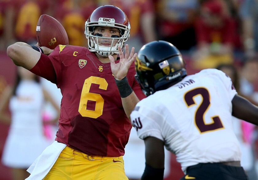USC quarterback Cody Kessler throws a pass in front of Arizona State linebacker Christian Sam during the Trojans' 38-34 loss to the Sun Devils at the Coliseum on Oct. 4, 2014.