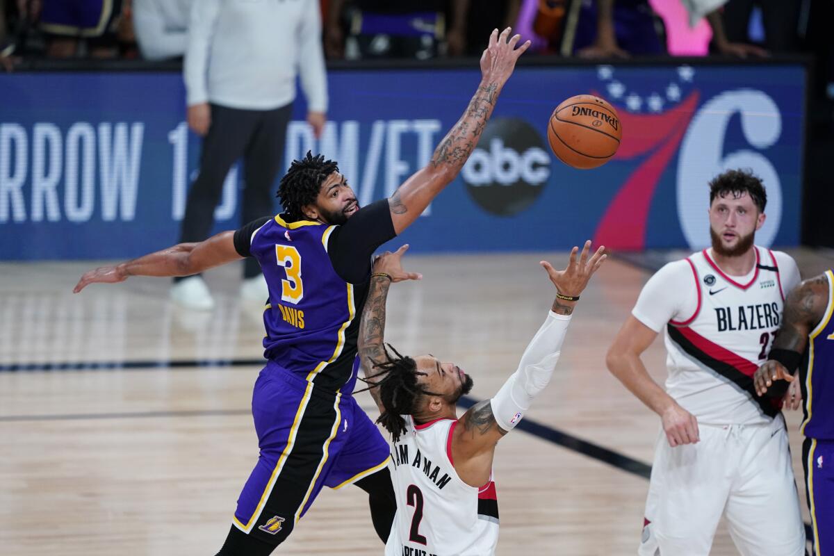 Lakers forward Anthony Davis forces Trail Blazers guard Gary Trent Jr. into a difficult shot during Game 3 on Saturday.