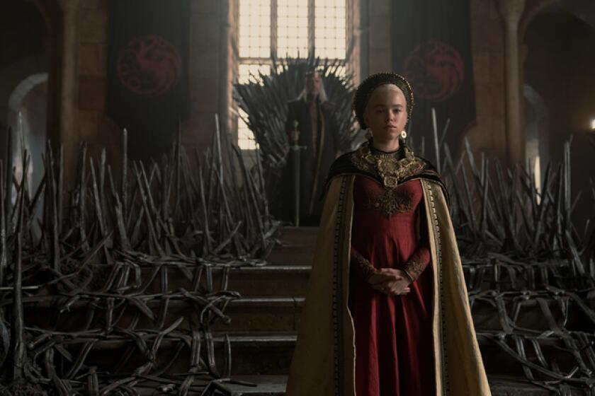 A teenage girl standing before her father on the throne