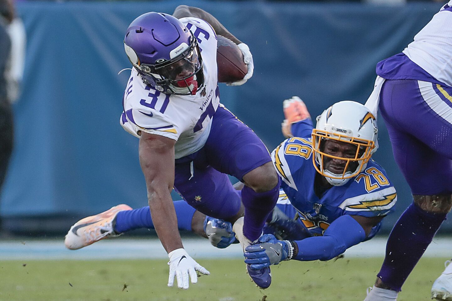 Minnesota Vikings running back Ameer Abdullah tries to break a tackle by Chargers defensive back Brandon Facyson.