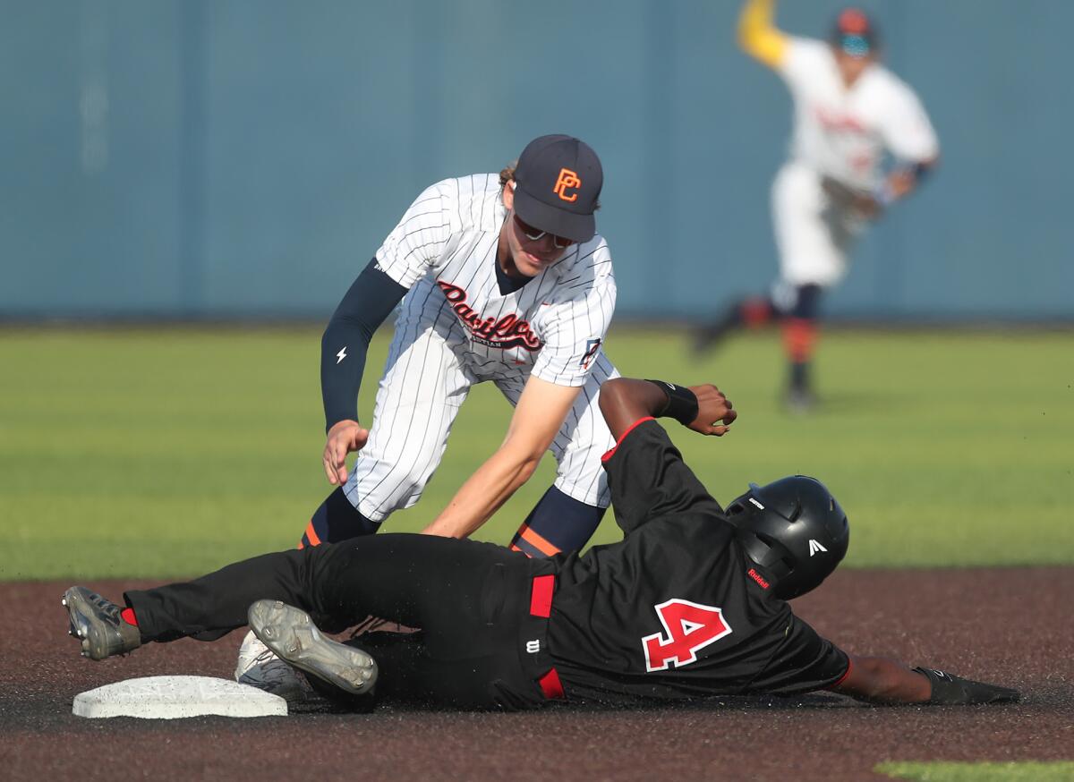 Pacifica Christian second baseman Johnny Coopman (10) tags out Isiah Wells (4) as he attempts to steal second base.