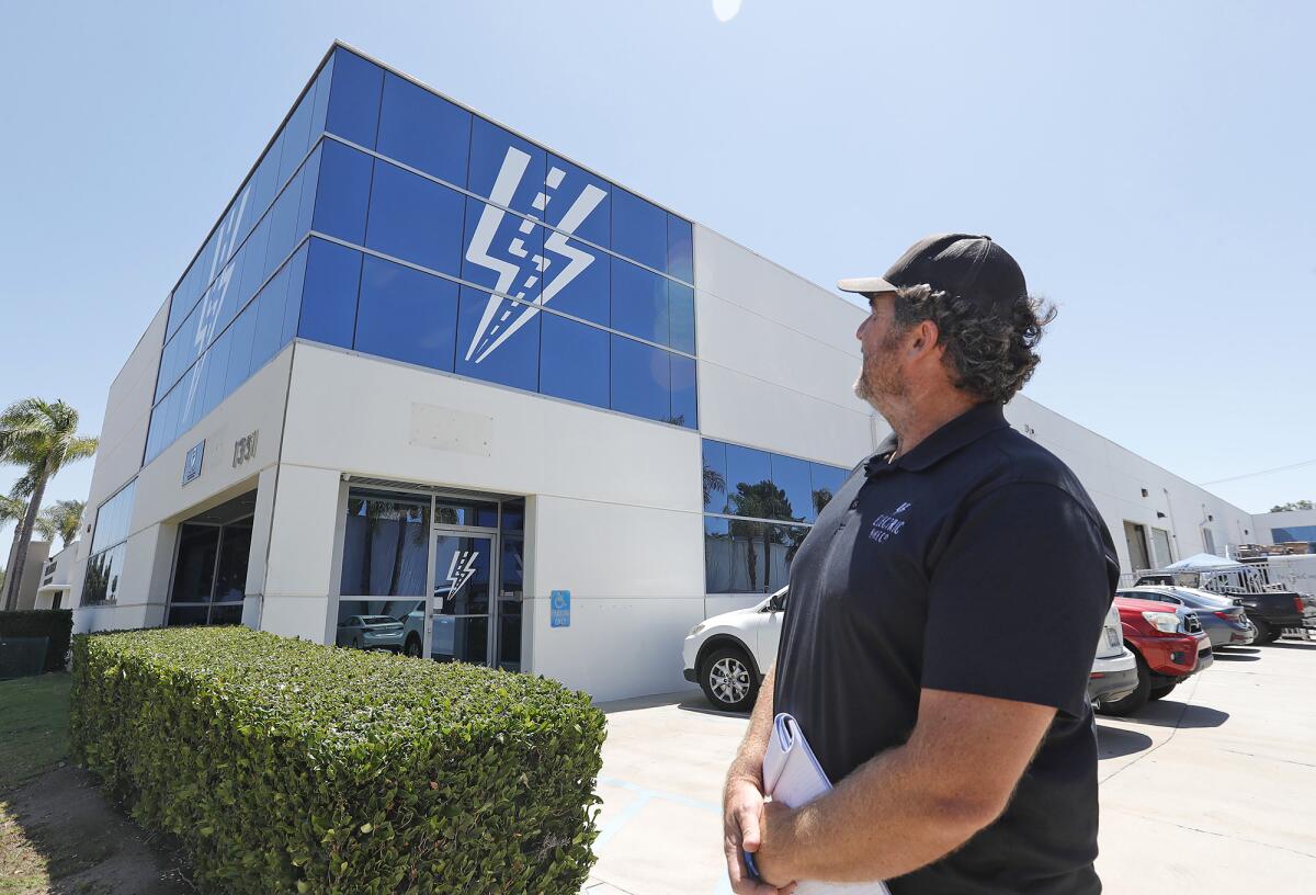 Owner Sean Lupton-Smith stands outside the new Electric Bike Co. production warehouse facility in Costa Mesa.