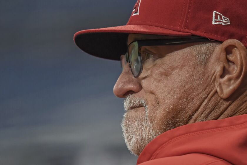 Los Angeles Angels manager Joe Maddon watches his team warm up before a baseball game against the Tampa Bay Rays Friday, June 25, 2021, in St. Petersburg, Fla. (AP Photo/Steve Nesius)