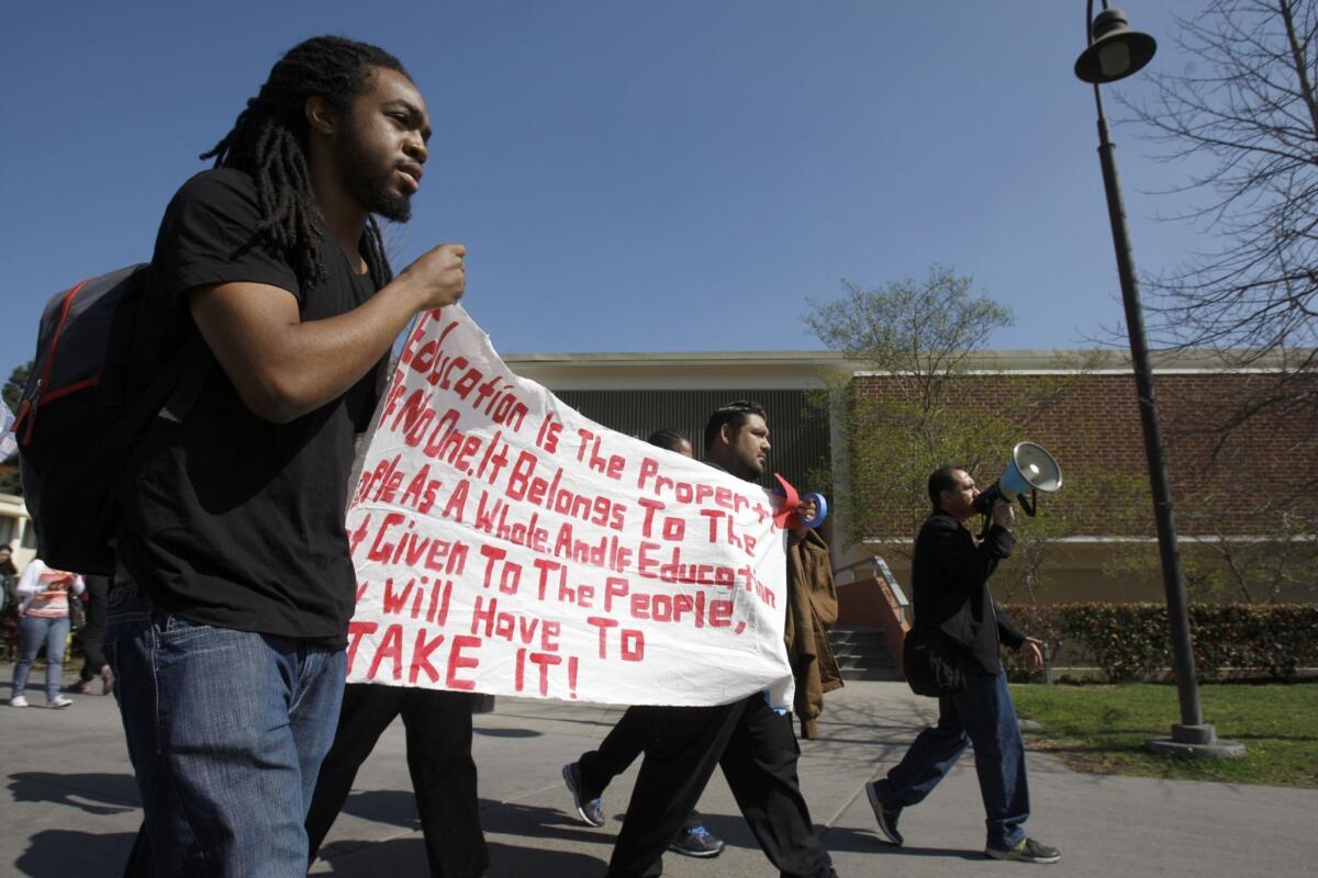 Ijazz Brooks, an international business student, walks with other students protesting at Cal State Los Angeles for an ethnic studies requirement.