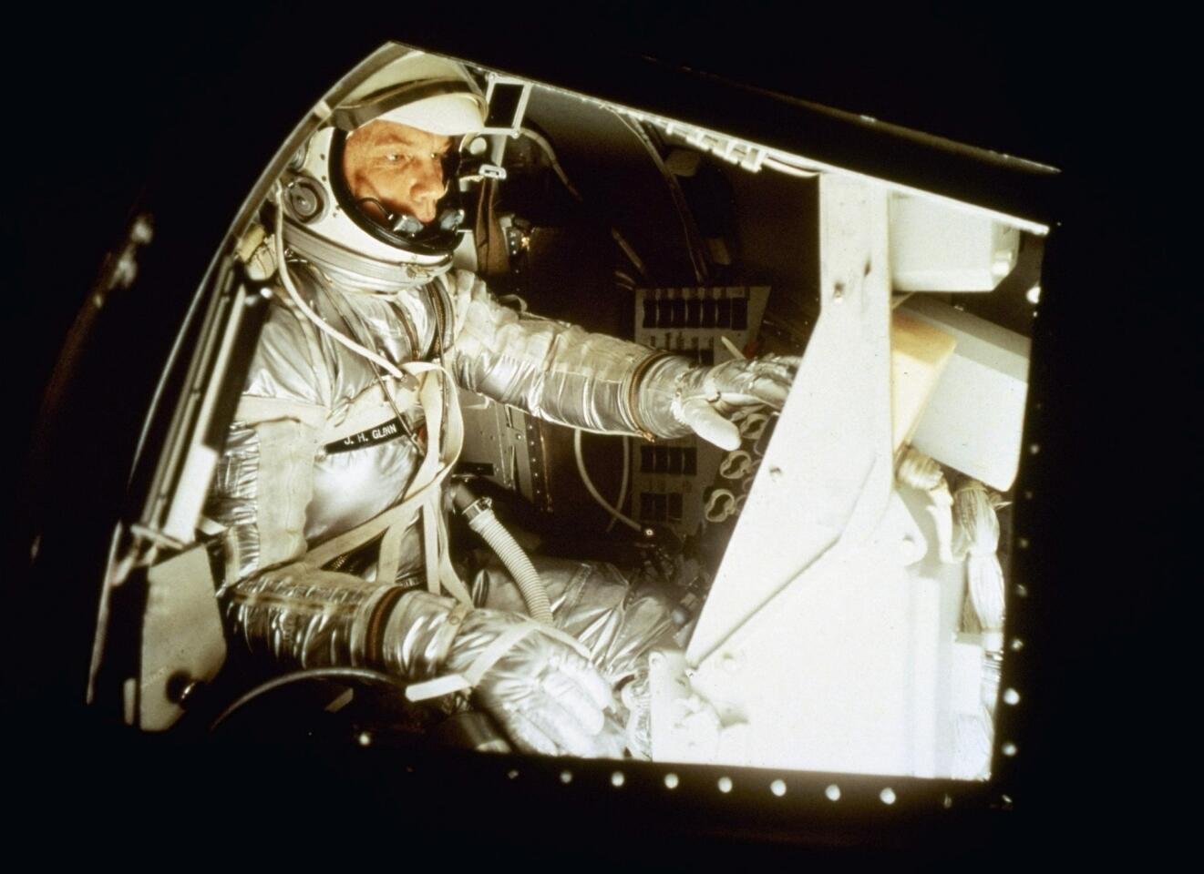 John Glenn sits inside the training capsule, January 11, 1961, in preparation for manned space flight.