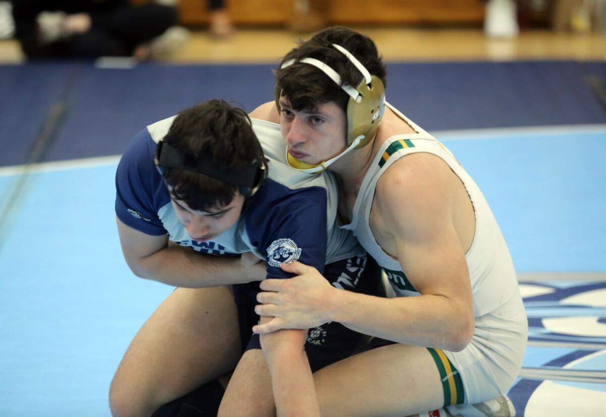 Edison's Jacob Iida, right, competes in a 152-pound semifinal match during the Sunset Conference wrestling finals at Corona del Mar High School on Saturday.