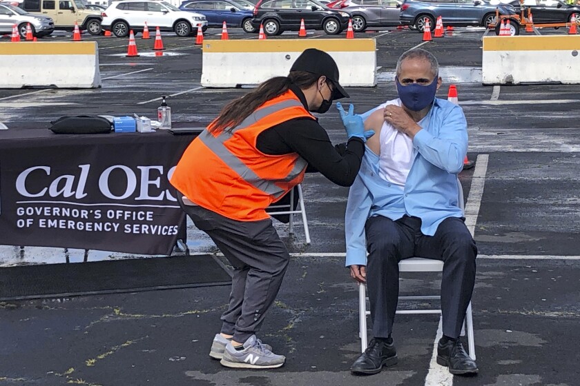 Dr. Tomas Aragon takes part in a vaccination event on March 11 at the RingCentral Coliseum in Oakland.