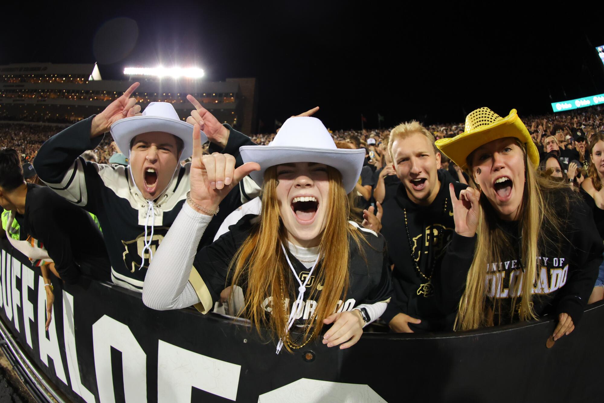 Colorado fans wearing rancher hats cheer during the team's game against Colorado State