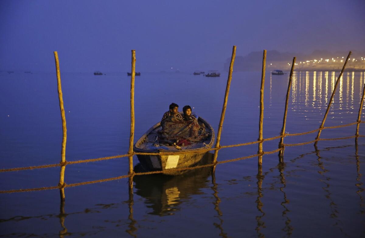Indian boatmen wait for devotees on the eve of the Hindu festival Makar Sankranti at Sangam, the confluence of the rivers Ganges, Yamuna and the mythical Saraswati. Bodies were "buried" in the Ganges about 150 miles to the north.