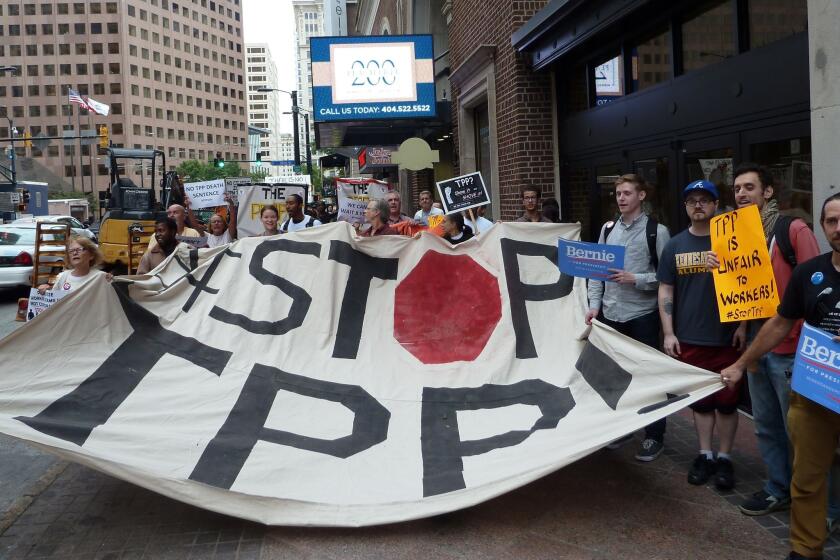 Protestors call for the rejection of the Trans-Pacific Partnership trade deal under negotiation in Atlanta on Thursday.