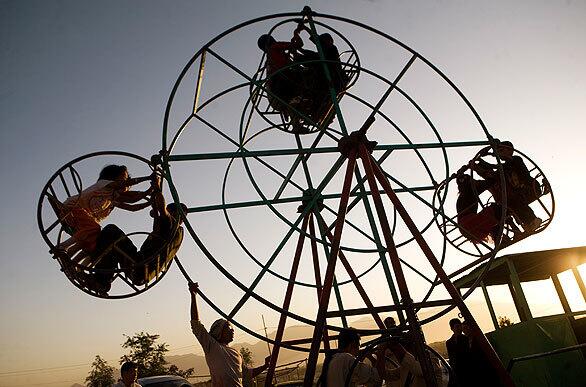 Afghan children enjoy a ride Friday.