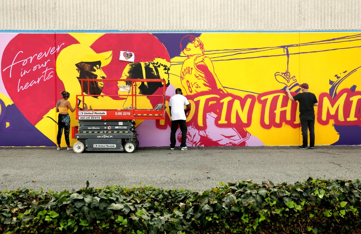 Mikala Taylor, left, Tony Concep, center, and Michael Ziobrowski collaborate on a mural in Santa Ana.